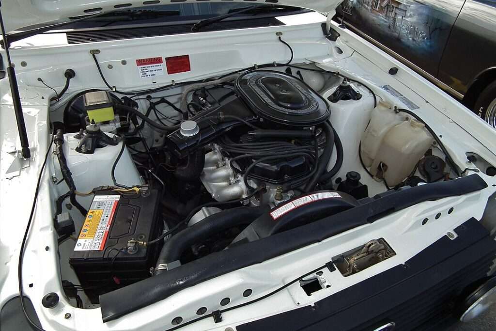 Image of a car engine with a clear view of the car battery