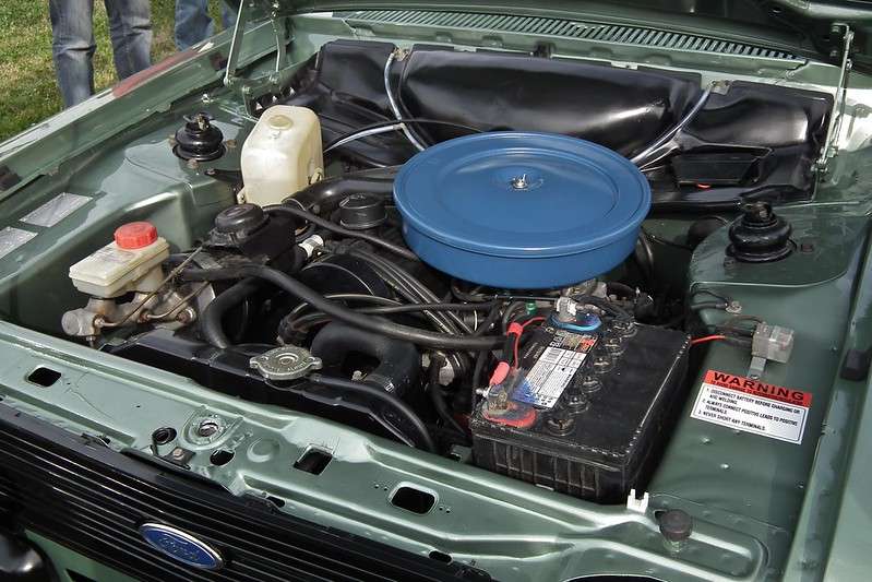 Image of a car engine with a clear view of the car battery