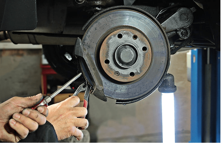 Mechanic person fixing car brake set