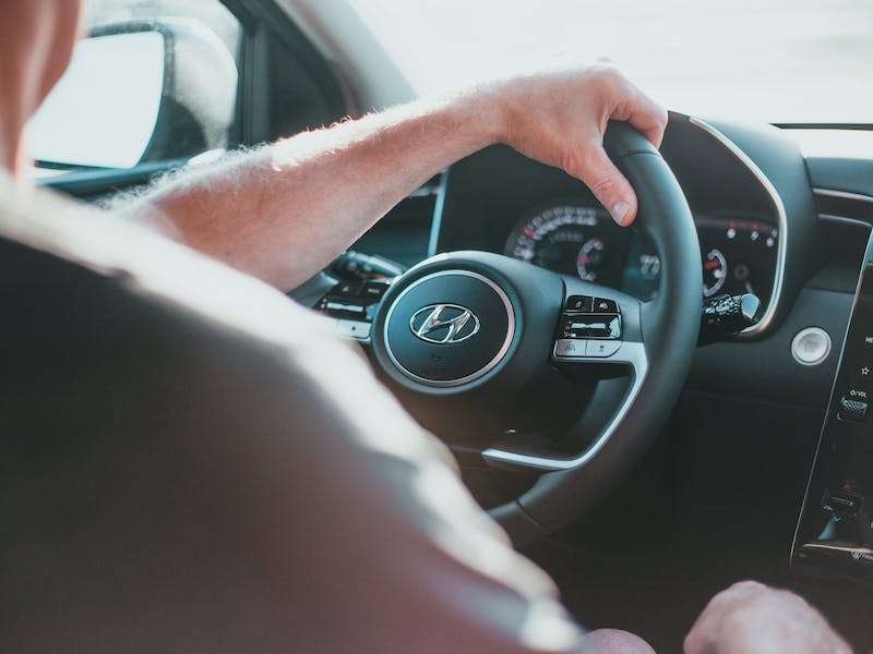 Hands holding a Honda Steering wheel
