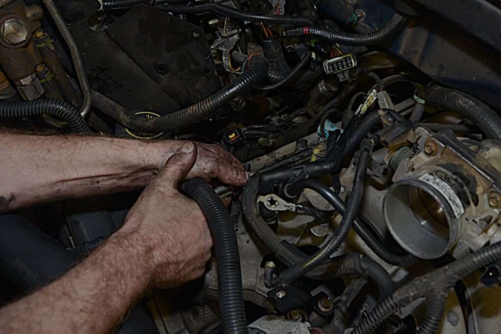 performing repairs under the engine hood of a vehicle